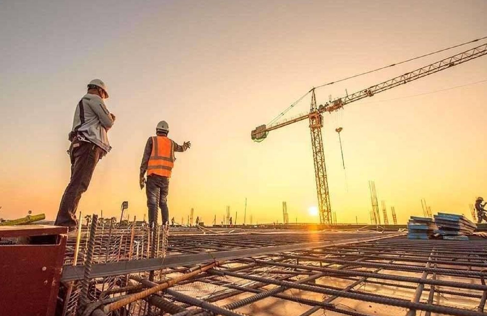 Engineers on a construction site at sunset