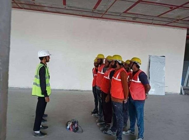 Site safety briefing with crew in PPE